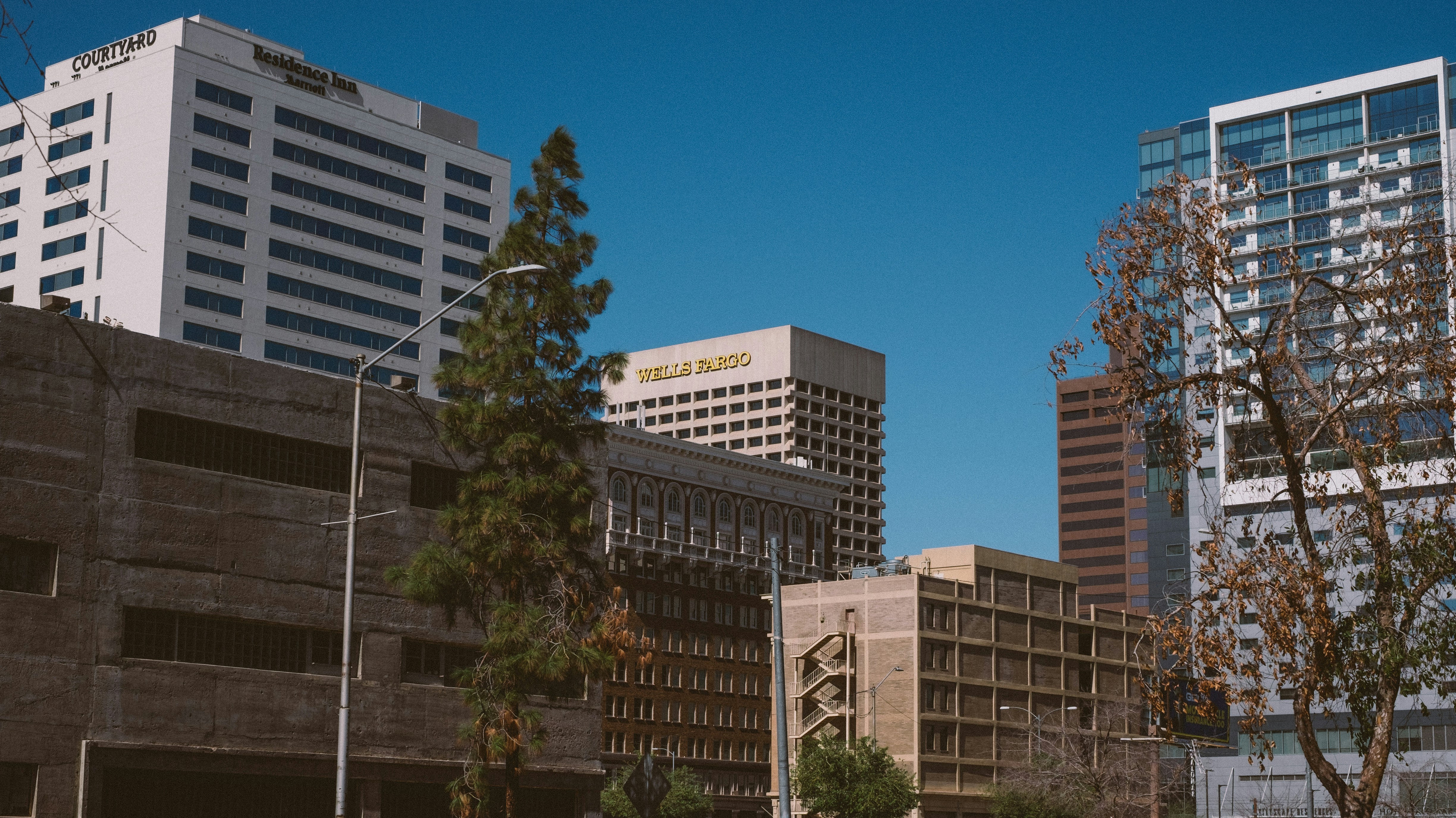 a city street with tall buildings in the background