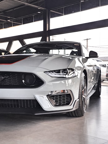 a white sports car parked in a garage