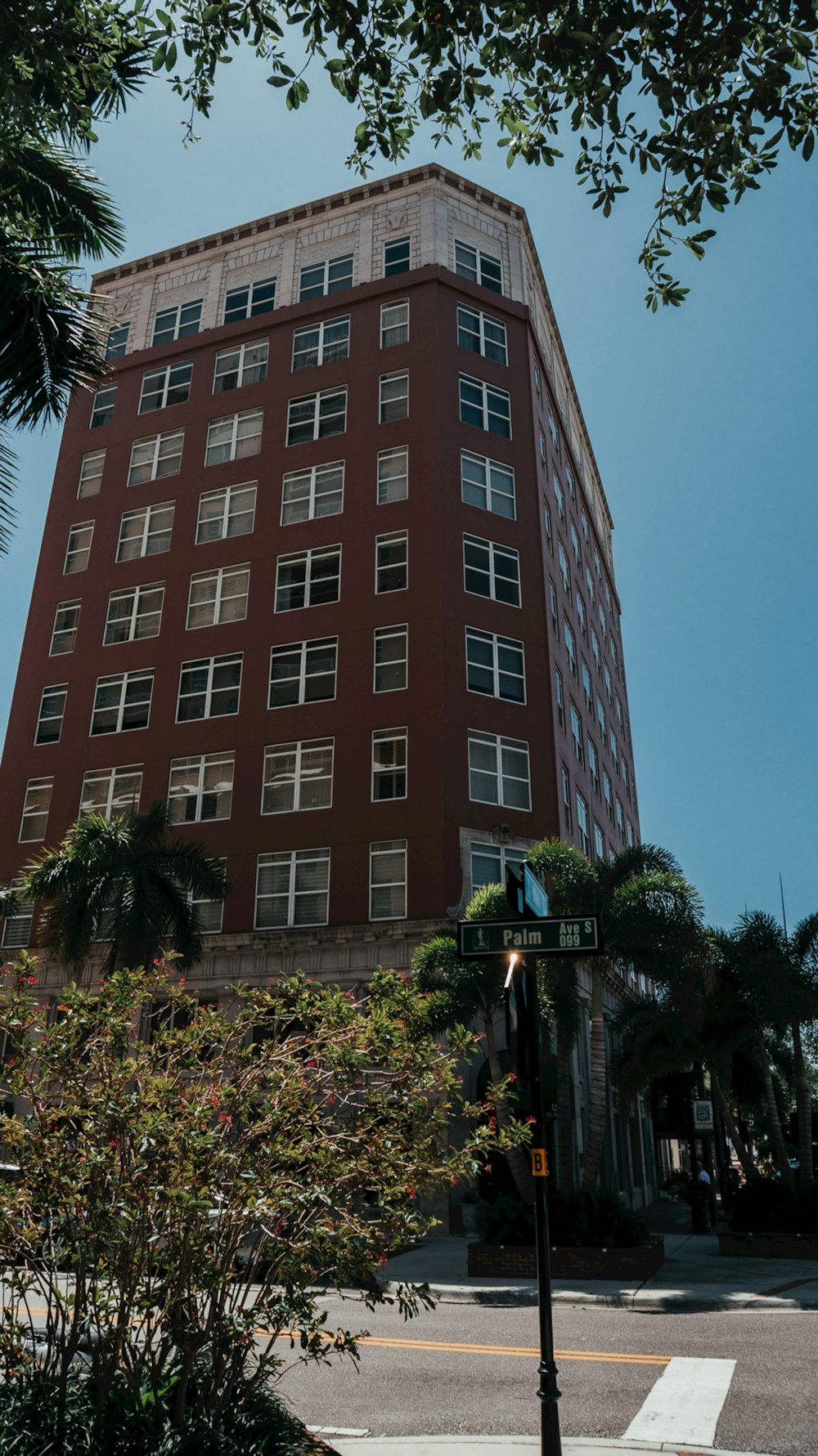 a tall red building sitting on the side of a road