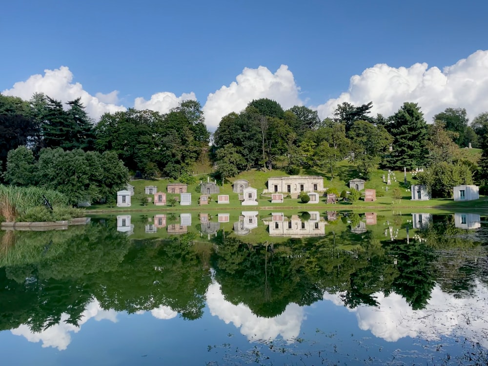 a body of water surrounded by trees and clouds