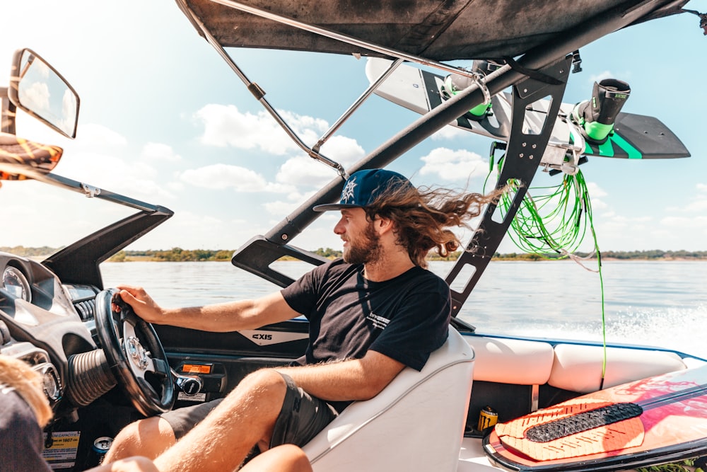 a man driving a boat on a body of water