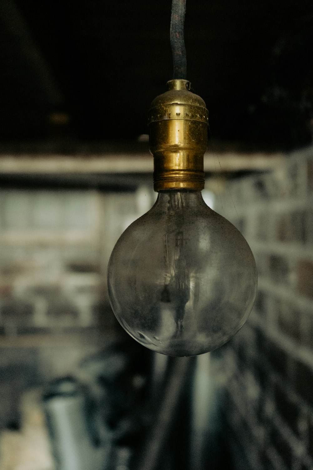 a light bulb hanging from a brick ceiling