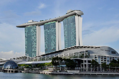 a very tall building sitting next to a body of water