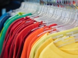 a rack of shirts hanging on a rack in a store