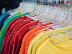 a rack of shirts hanging on a rack in a store