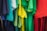 A collection of colorful t-shirts hanging closely together, showcasing an array of vibrant colors including shades of blue, green, yellow, and red. The shirts appear to be made of soft fabric and are displayed side by side, giving a sense of variety and brightness.