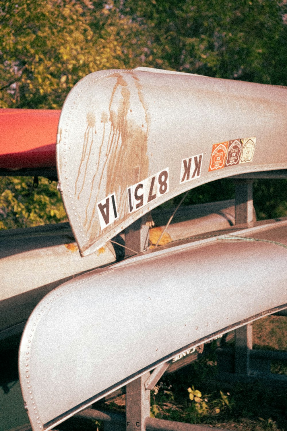 a close up of a metal object with trees in the background