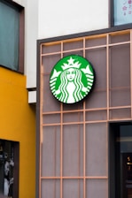 a starbucks sign on the side of a building