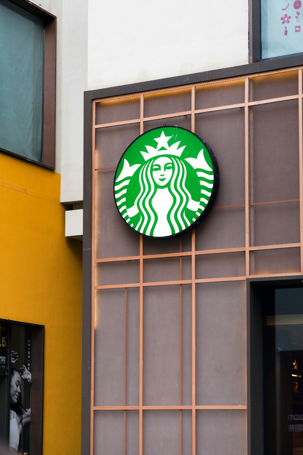 a starbucks sign on the side of a building