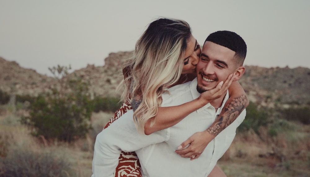 a man and a woman hugging in the desert