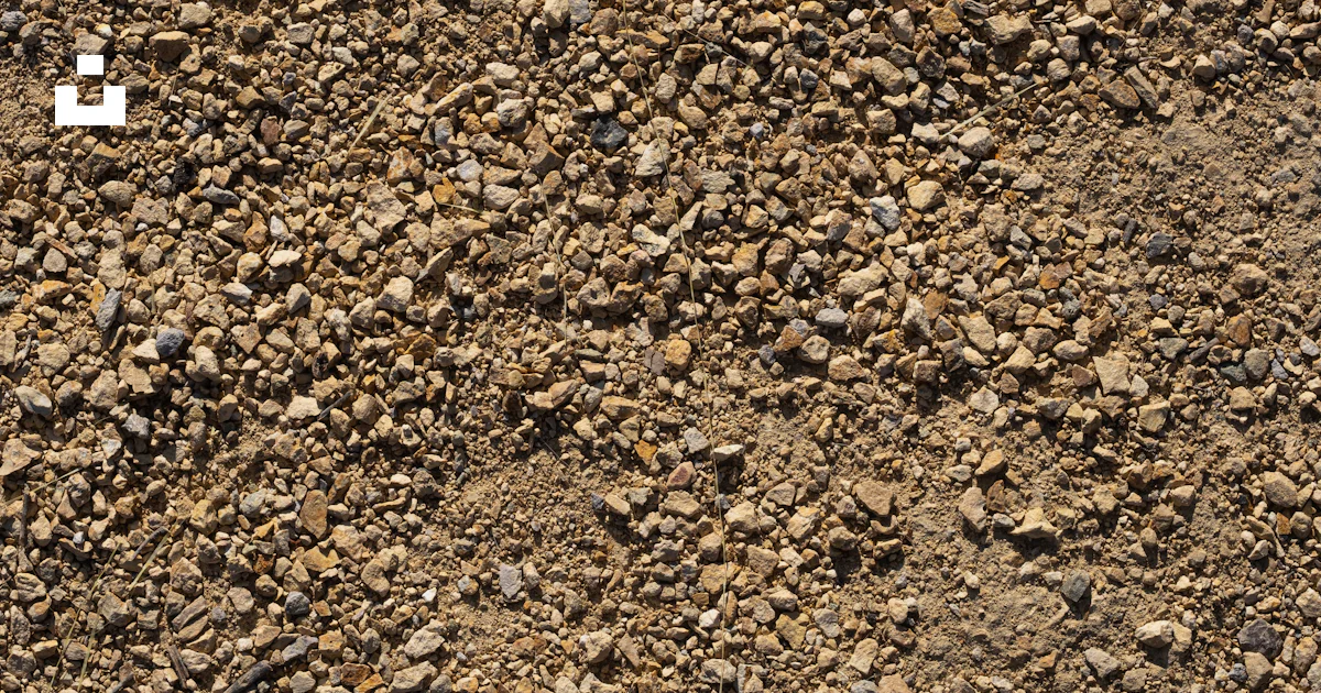 A close up of a dirt surface with rocks and gravel photo – Free De luz ...