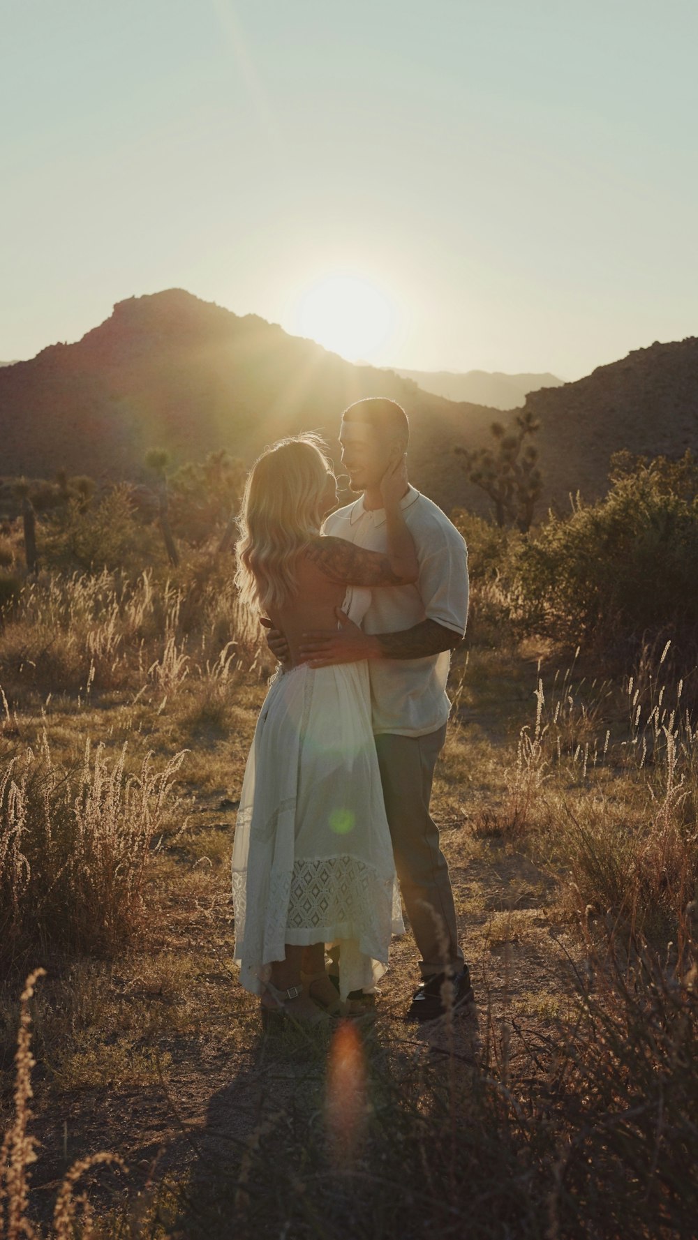 a man and a woman embracing in a field