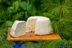 a piece of cake sitting on top of a wooden cutting board