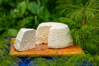 a piece of cake sitting on top of a wooden cutting board