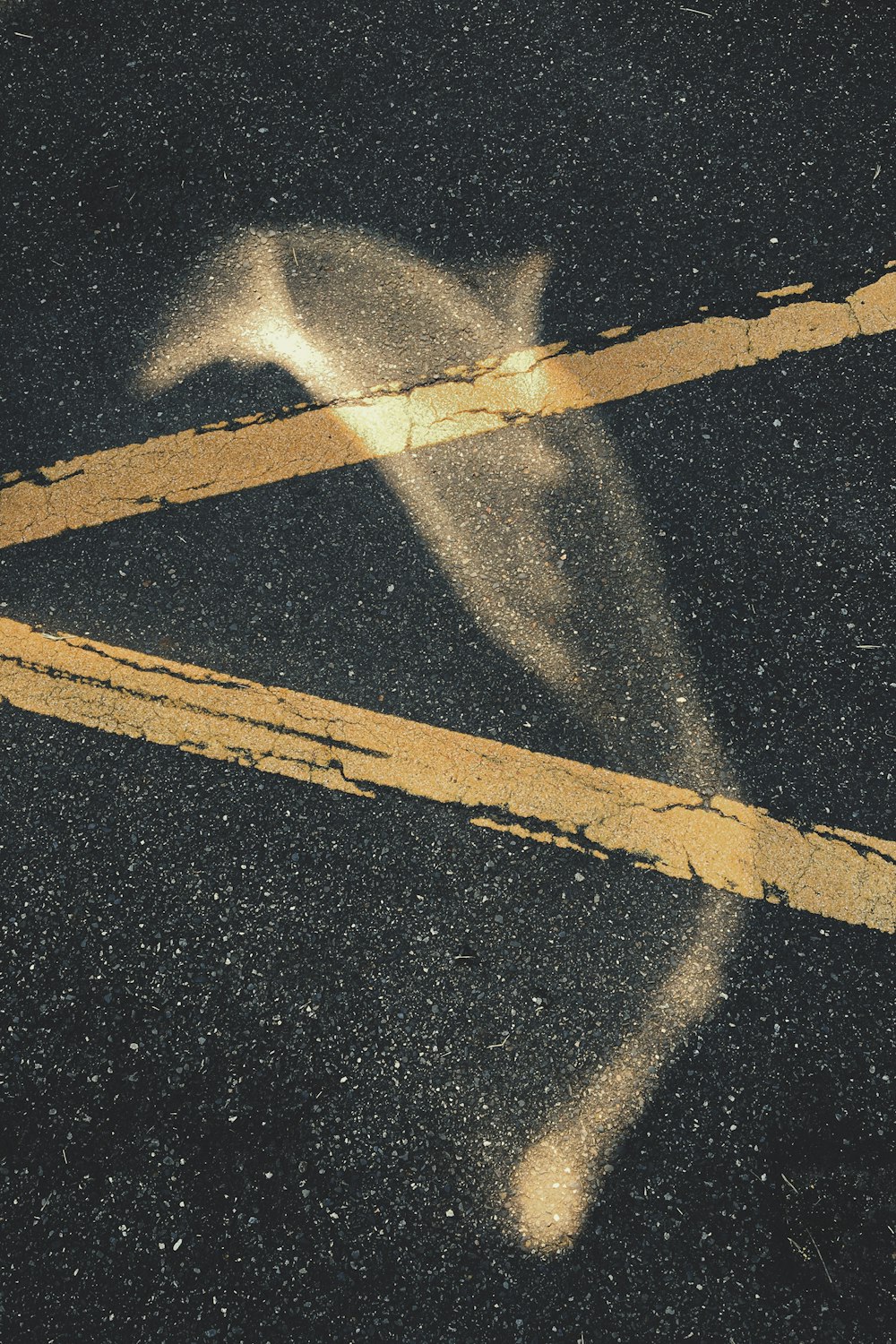 a yellow line painted on the asphalt of a street