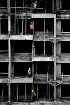 a group of men standing on top of a building under construction
