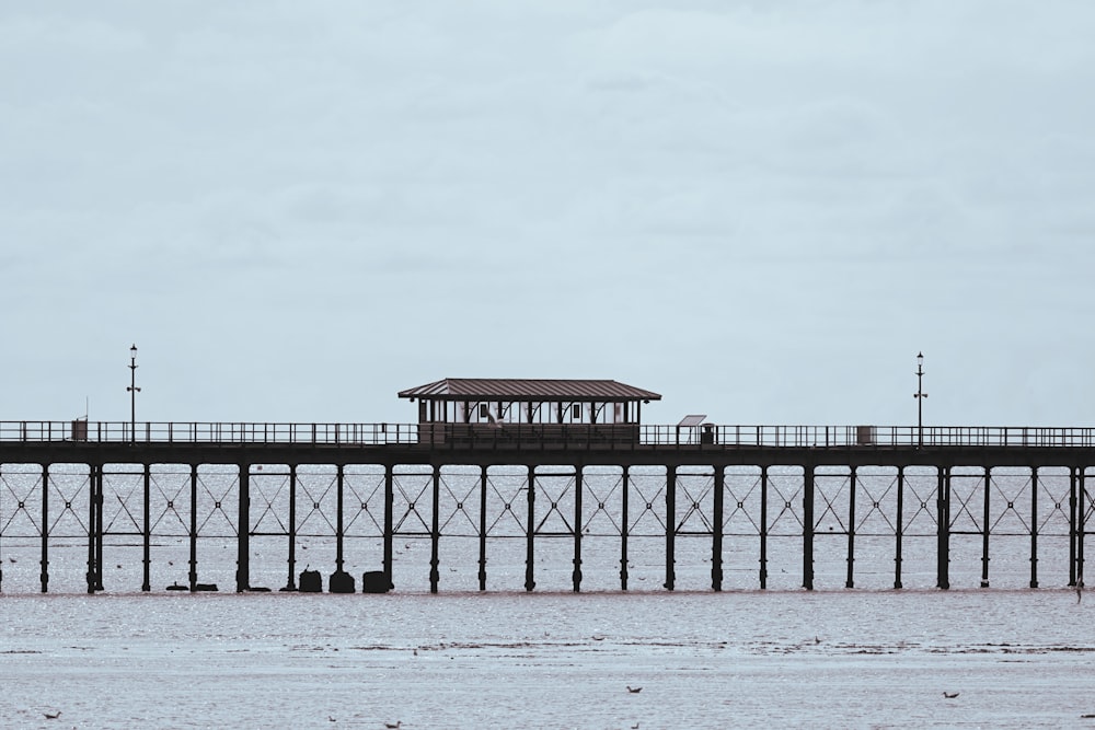 a pier with a small building on top of it