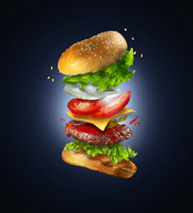 Animated layers of a classic hamburger assembling perfectly with fresh salad and a toasted bun.