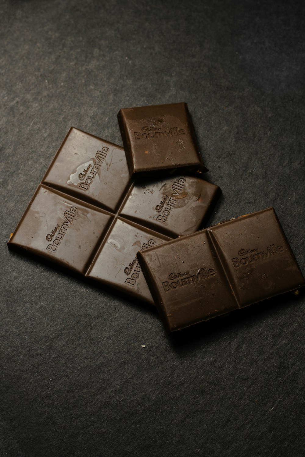 four pieces of chocolate sitting on top of a table