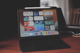 a laptop computer sitting on top of a wooden desk