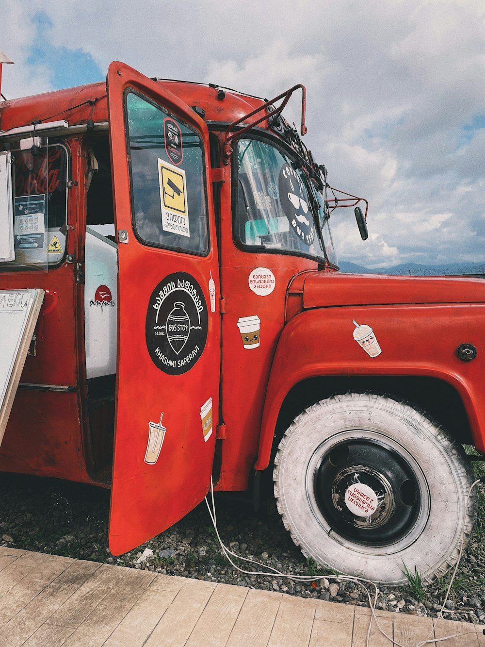 a red truck with a sign on the side of it