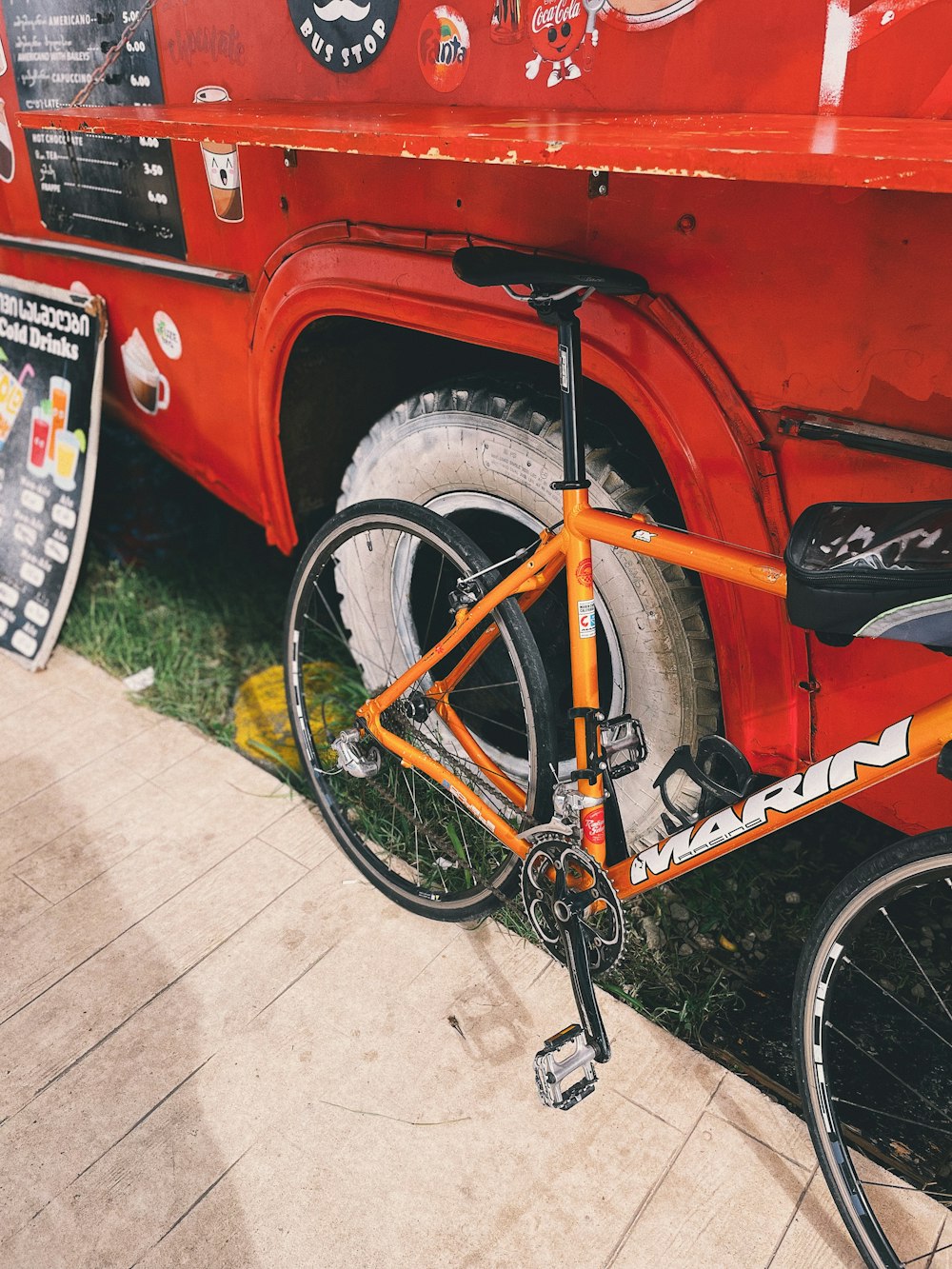 a bike parked next to a red truck