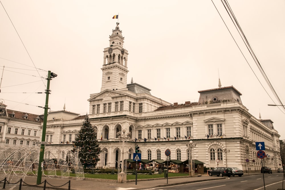 a large white building with a clock tower