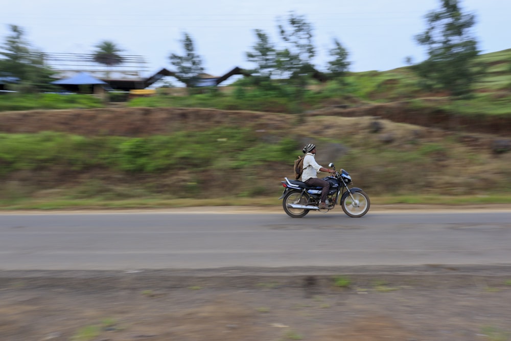 a man riding a motorcycle down a curvy road