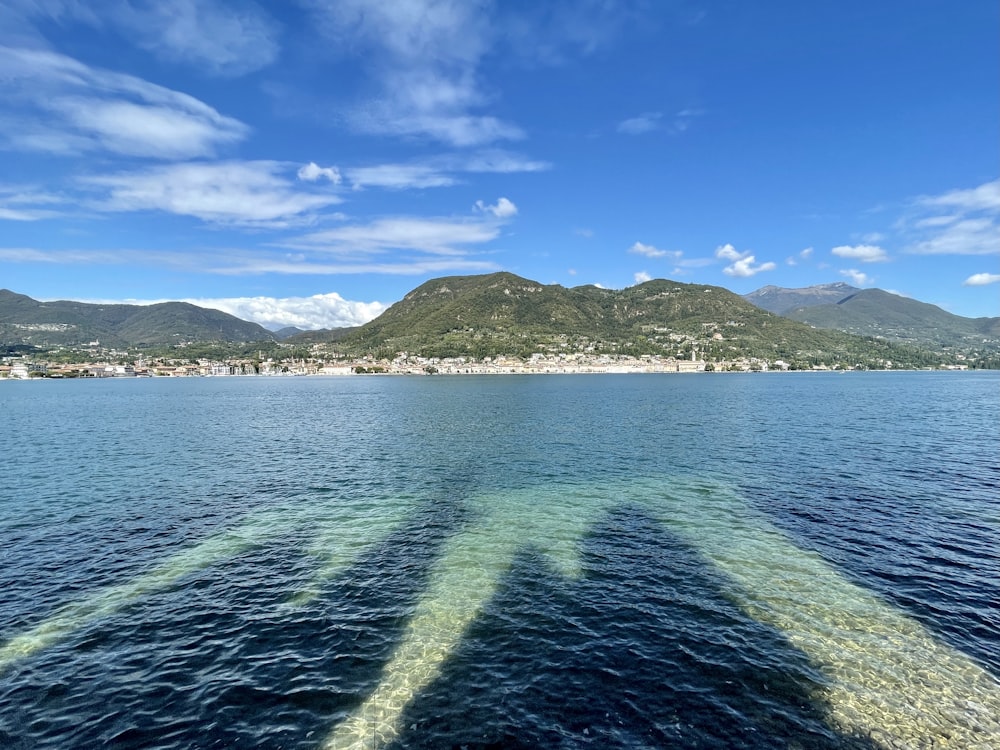 a body of water with mountains in the background