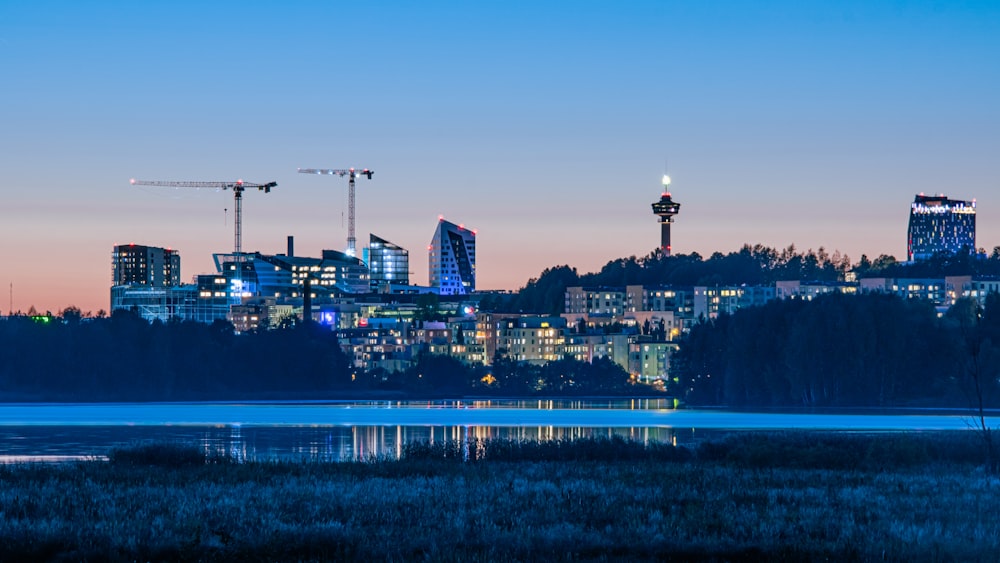 a view of a city with a lake in the foreground