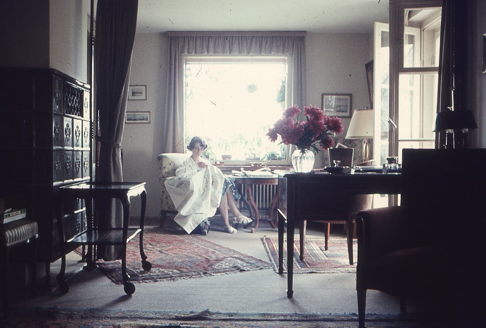 a woman sitting on a couch in a living room