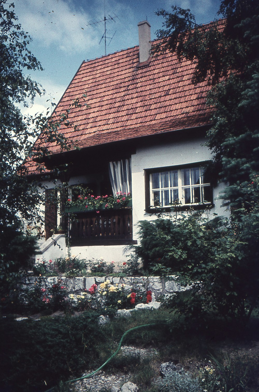 a small white house with a red roof