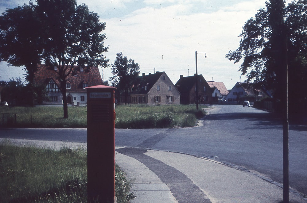 an empty street with houses in the background