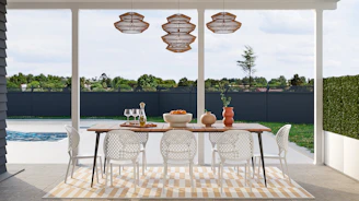 a dining room with a table and chairs next to a pool
