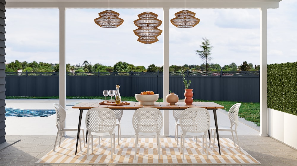 a dining room with a table and chairs next to a pool