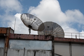 a couple of satellite dishes sitting on top of a building