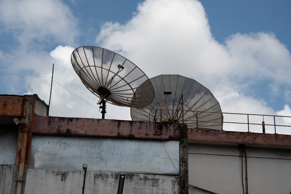 a couple of satellite dishes sitting on top of a building