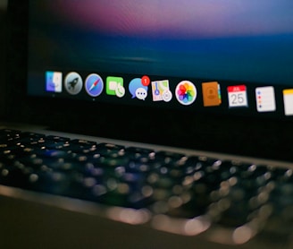 a close up of a laptop computer with icons on the screen