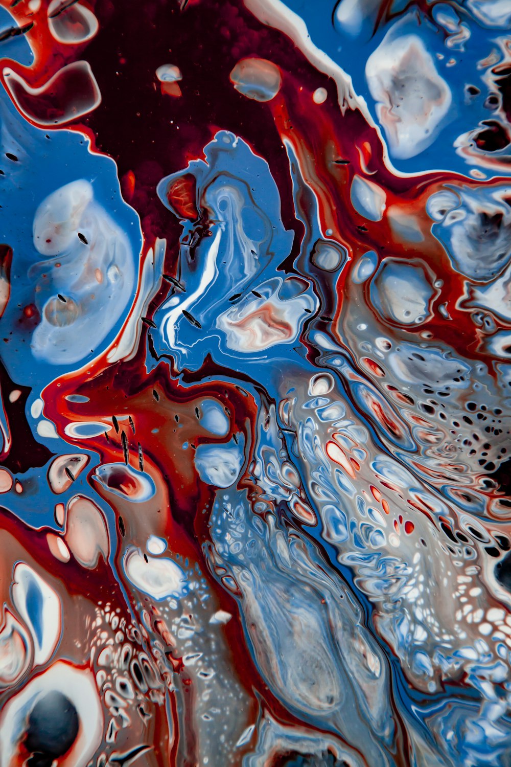 a close up of a red, white and blue liquid