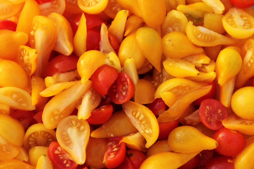 a pile of yellow and red tomatoes
