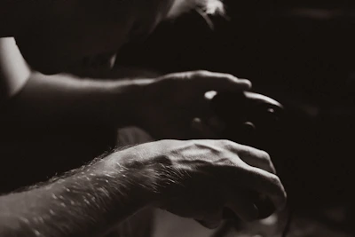 Close-up of a player’s hands gripping a controller, focused and ready.