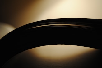 Stack of printable disclosure documents on a dark gray desk, softly lit for easy reading.