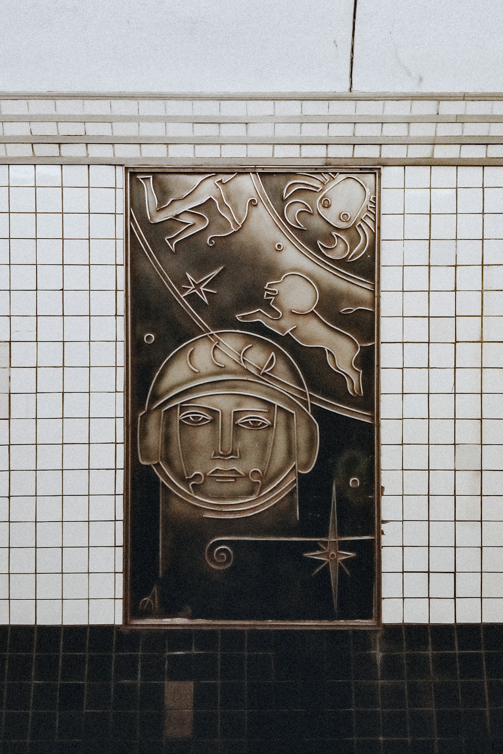 a picture of a man in a space suit on a tile wall