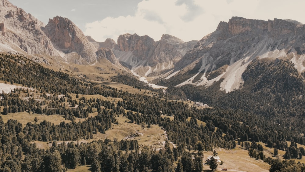 a view of a mountain range with trees and mountains in the background