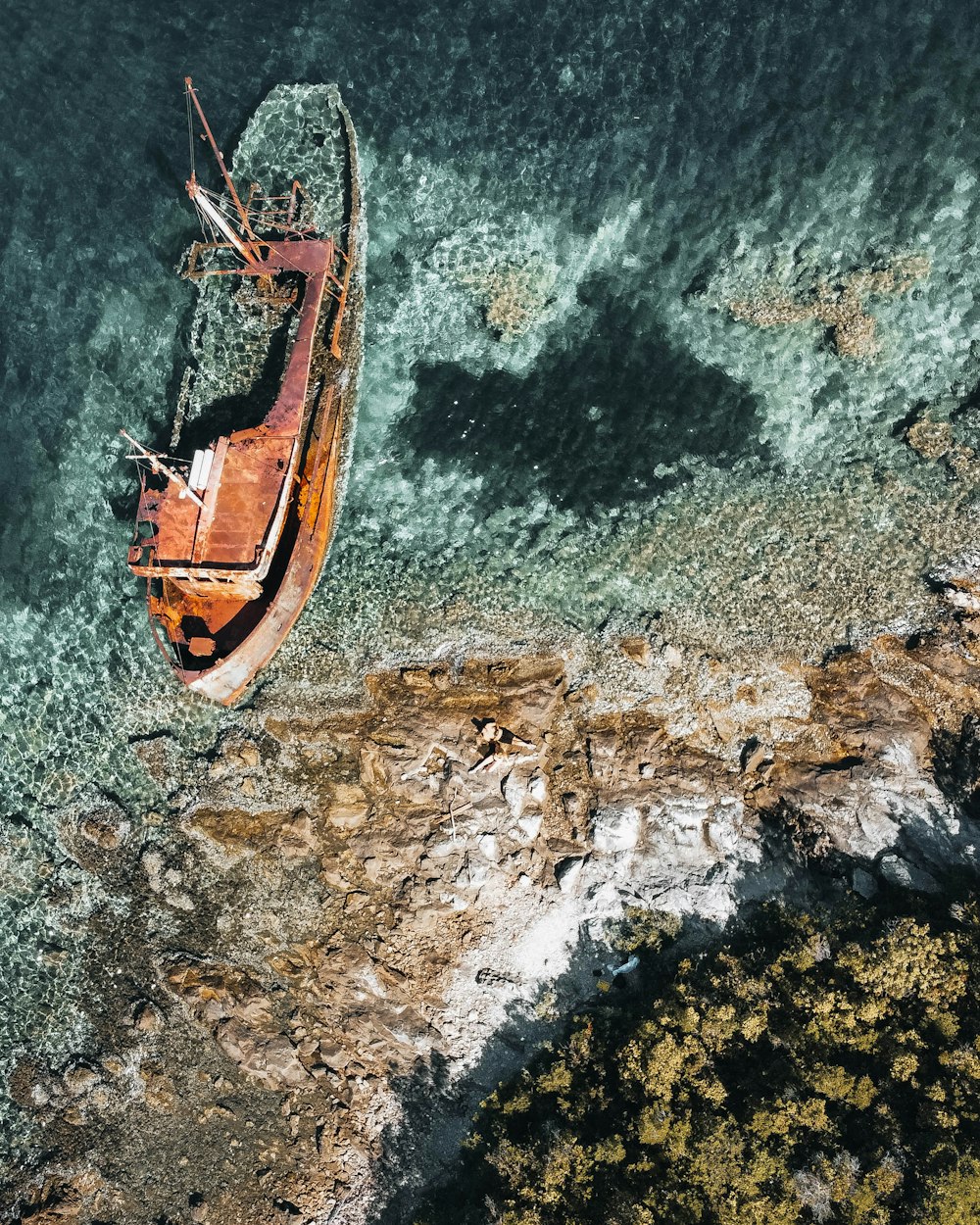 an aerial view of a boat in the water