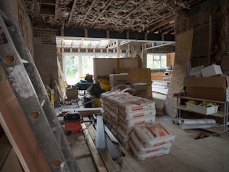 a room filled with lots of boxes and a ladder