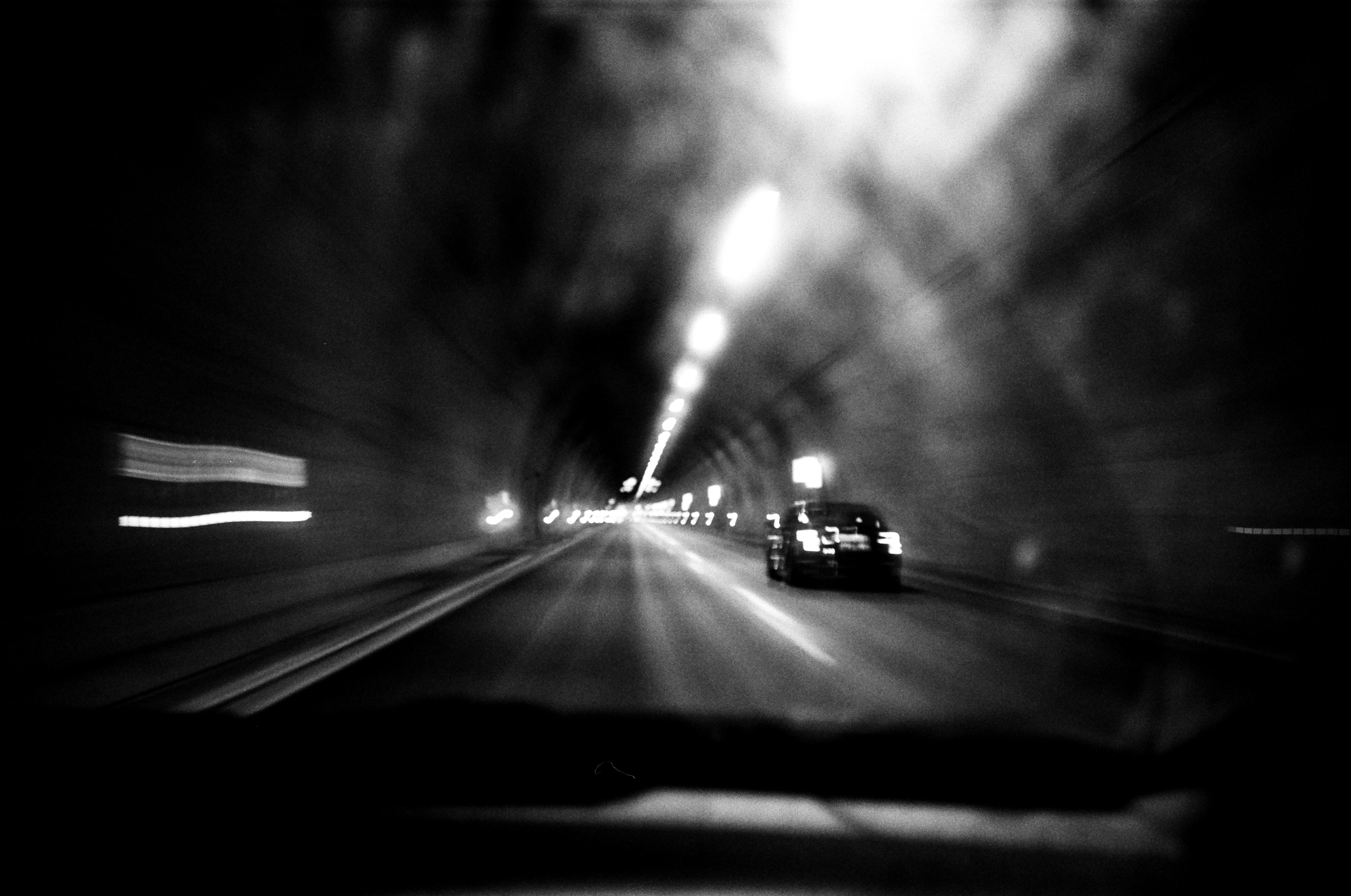 a car driving down a street at night, Support me & my work: https://linktr.ee/mpozniak