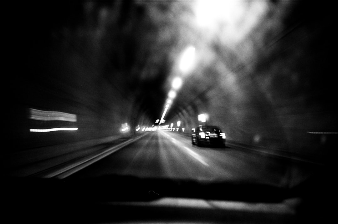 a car driving down a street at night, Support me & my work: https://linktr.ee/mpozniak