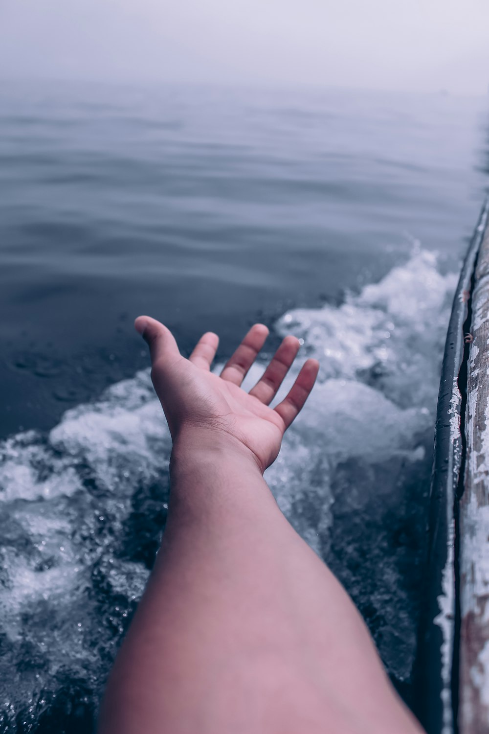 a person is sitting on a boat in the water