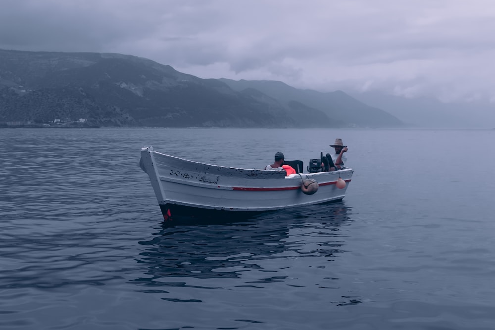 a small boat floating on top of a large body of water